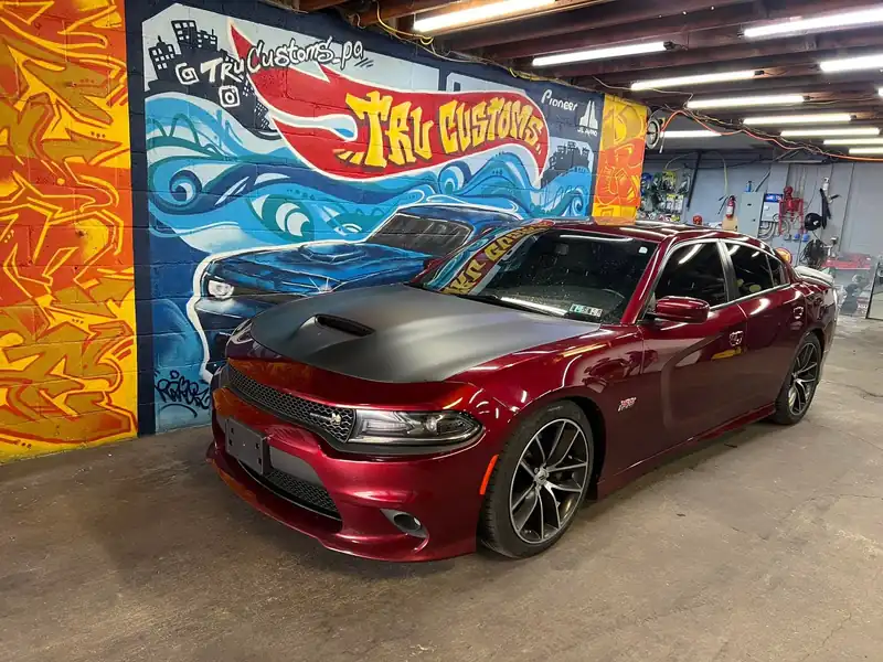 Dark red Dodge Charger Scat Pack with a matte black hood