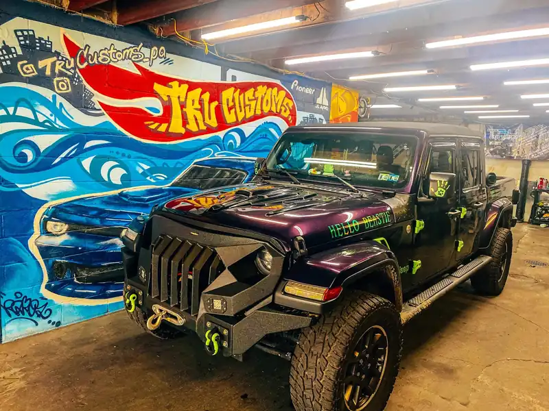Purple Jeep Gladiator with a black armored front bumper and lime green accents