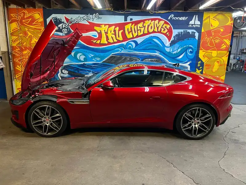 Red Jaguar F-Type coupe with the hood open