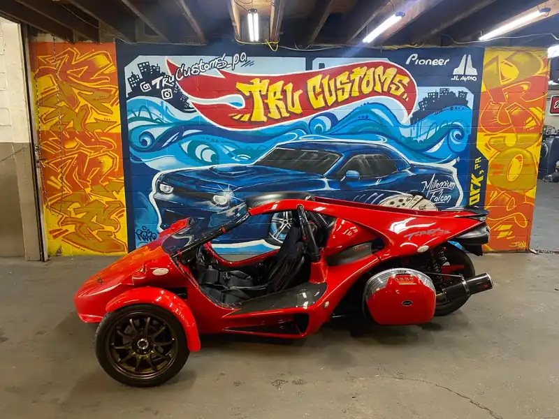 Red Campagna T-Rex three-wheeler with bronze wheels