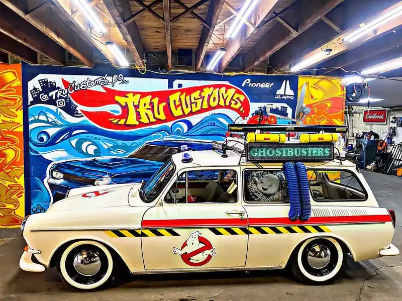 White vintage Volkswagen Squareback wagon built as a movie replica with roof equipment and an LED sign