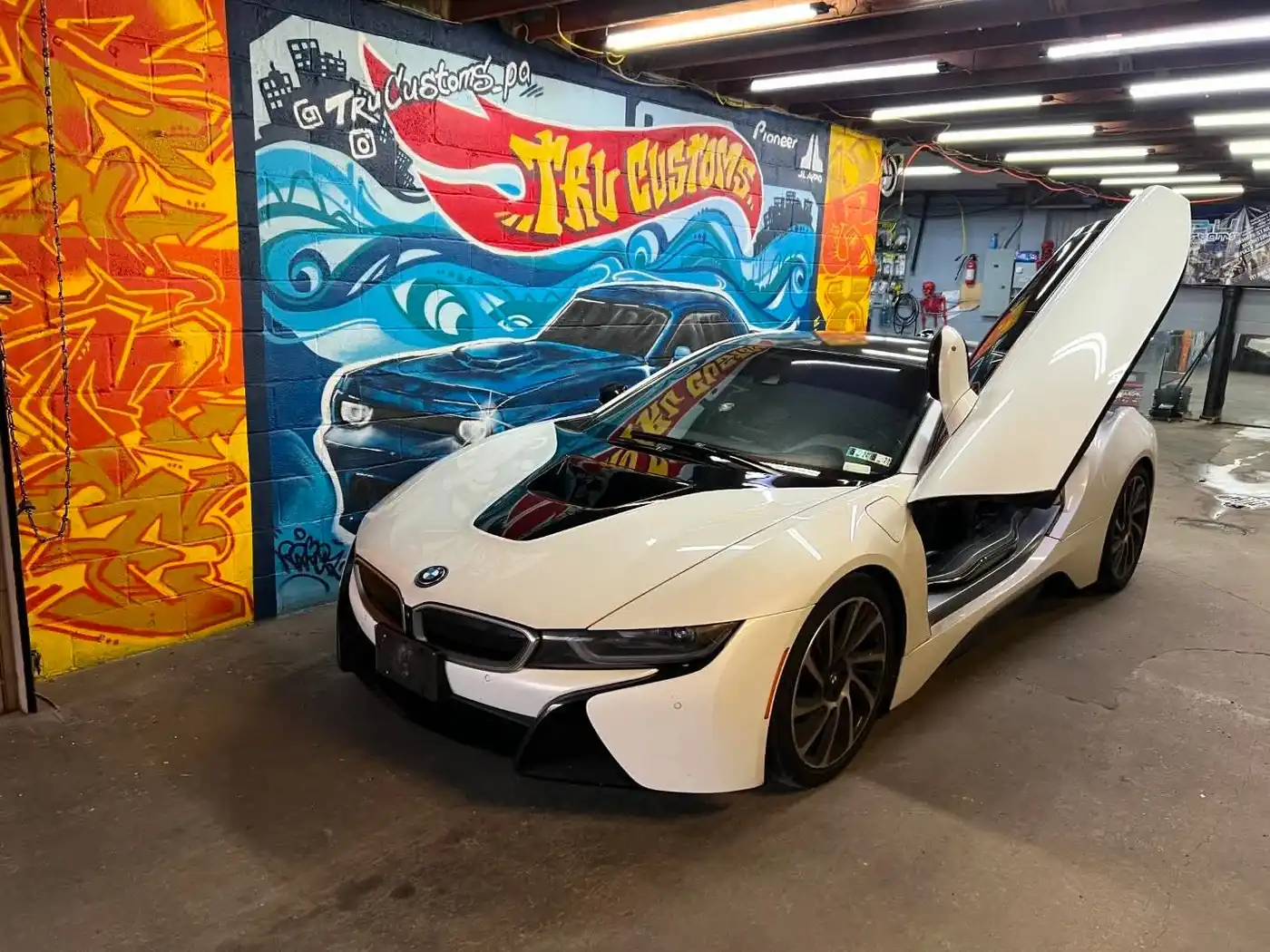 White BMW i8 with its butterfly door open