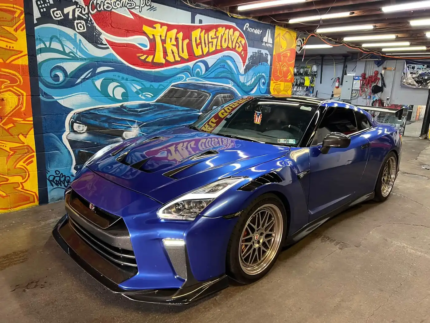 Blue Nissan GT-R with carbon aero parts and gold multi-spoke wheels